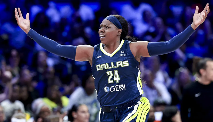 Arike Ogunbowale dribbling the basketball during a Dallas Wings game while leading the offense with a strong scoring performance.