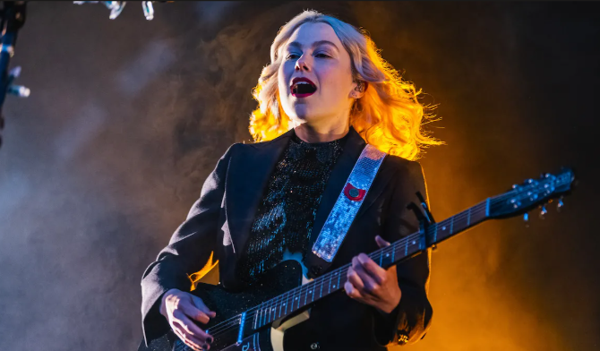 Phoebe Bridgers performing live on stage during her 2026 “The Lost Tour” announcement, with special guest Isaac Wood joining select European dates.